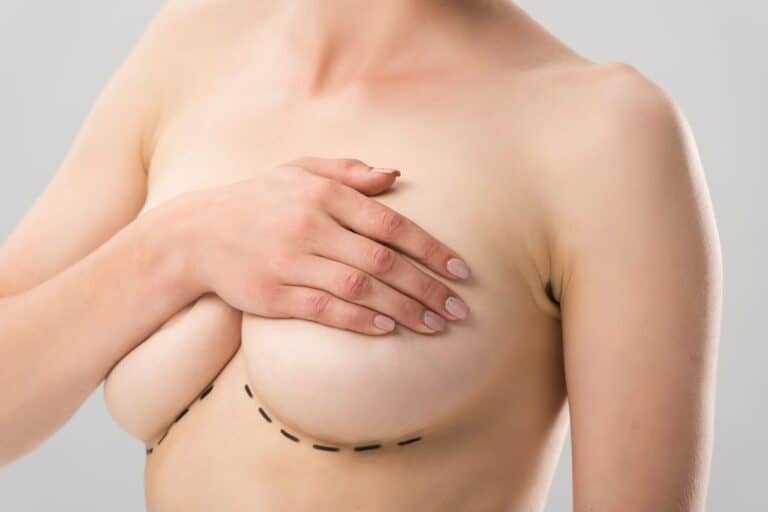 woman covering her breasts with one hand
