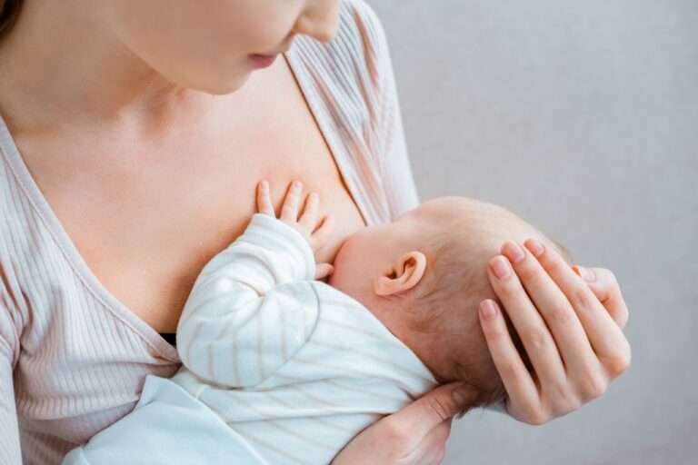 mom gently breastfeeding her baby