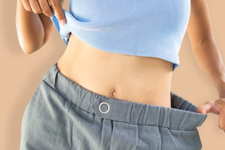 slim woman in blue top and wide shorts