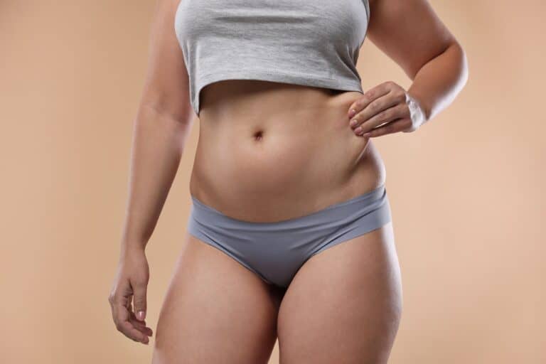 woman pinching her waist